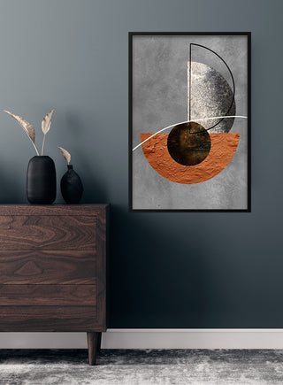 Minimalistic brown and silver abstract poster hanging on a dark wall above a wooden dresser with decor.