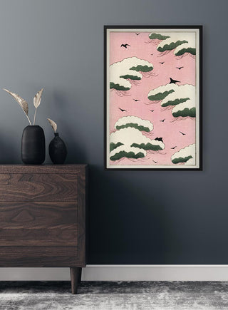 Framed "Pink sky" by Watanabe Seitei art poster displayed on a dark wall above a modern wooden dresser.