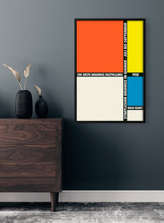 Bauhaus Ausstellung 1922 poster with bold geometric shapes in orange, blue, yellow, and white on a wall.