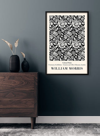 Framed "White Flowers" by William Morris poster on a dark wall above a wooden dresser with vases.