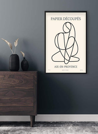 Minimalist art print "Papier Decoupe No. 01" with abstract black lines, framed and hung in a modern living room.