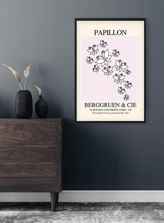 Minimalist floral line art poster with "Papillon" and "Berggruen & Cie" text, framed on a modern wall.