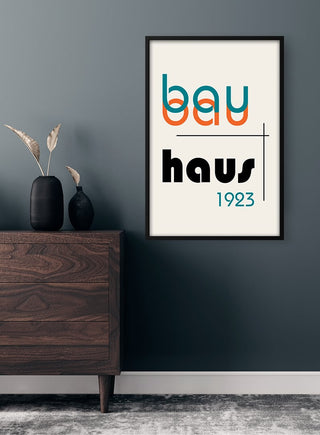 Framed Bauhaus 1923 Plakat artwork on a dark wall above a modern wooden dresser with decorative vases.