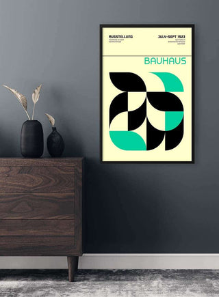 Framed Bauhaus Green Weimar Ausstellung Plakat with abstract geometric shapes hanging on a modern grey wall.