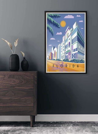 Framed Florida in Blue Plakat featuring art deco buildings, palm trees, and a sunlit street.