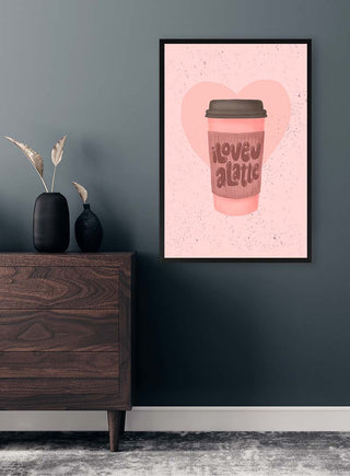 Framed "Love you a Latte" coffee cup art print with pink heart, displayed above a wooden dresser.