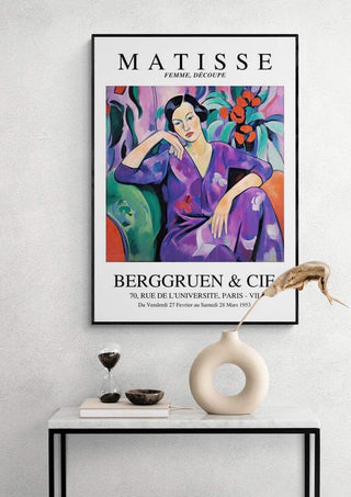 Framed "Matisse Purple Madame" art print displayed above a modern white console table with decor items.