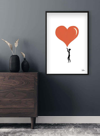 Sara Sonne-Hearts Kunstposter featuring a silhouette holding up a large red heart, framed on a modern wall.