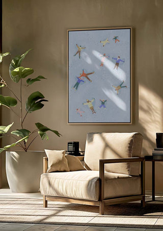 Framed "Snow Angels" by Bea Muller displayed above a beige armchair in a modern, sunlit living room.