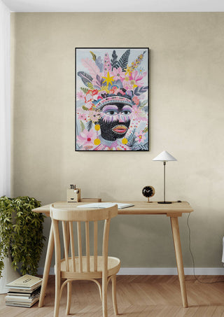 Framed "The Tribe Called Art - Vincent V." artwork hanging above a wooden desk in a modern home office.