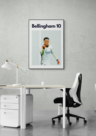 Bellingham Real Madrid football poster displayed on an office wall above a modern desk and chair.