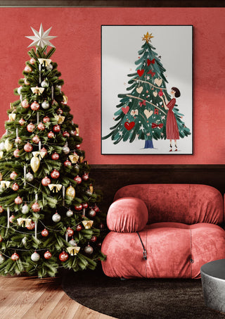 Festive living room with a decorated Christmas tree, pink chair, and holiday-themed artwork on the wall.