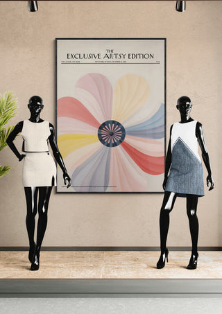 Two mannequins stand by a framed Spinning Flower Artsy Edition poster on display in a modern showroom.