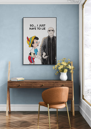 Framed "Just Lie - Daniel Leo" artwork featuring Pinocchio and a suited man, displayed above a wooden desk.