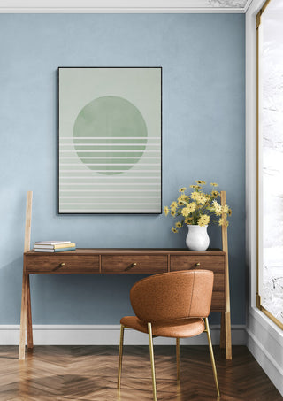 Green Horizon Lines artwork hanging above a wooden desk in a modern, sunlit room with blue walls.