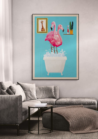 Framed wallchart of two flamingos in a white bathtub with bubbles, displayed above a gray sofa in a modern living room.