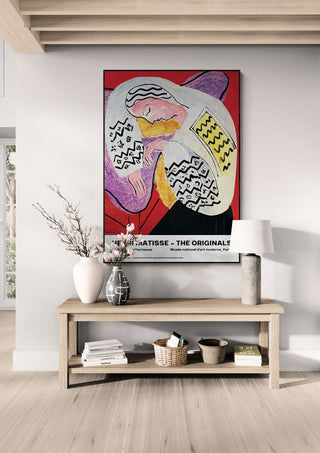 La Rêve ou La Dormeuse by Henri Matisse displayed above a wooden console table in a modern living room.