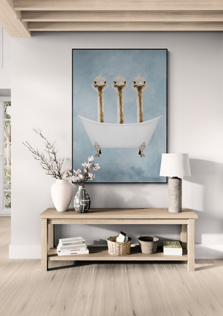 Framed "Ostriches in Bathtub - Coco de Paris" art displayed above a wooden console table in a modern room.