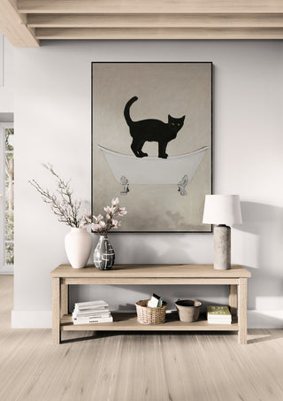 Framed art of a black cat on a bathtub, displayed above a wooden console in a modern living room.