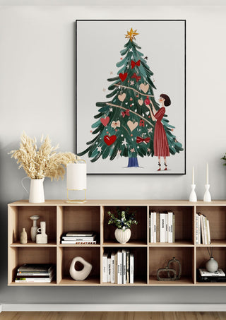 Wall art of a woman decorating a Christmas tree, displayed above a festive modern console shelf.