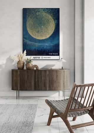 The Moon by Martin Zen artwork displayed above a wooden console in a modern living room setting.