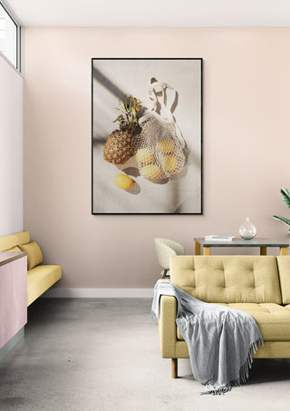 Framed wall art featuring pineapples and lemons, highlighting fresh summer fruits in a modern living room.