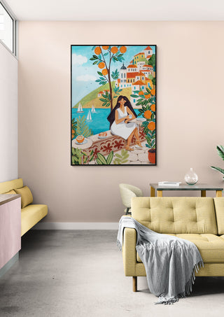 A woman relaxes by the Mediterranean coast, surrounded by colorful flowers and seaside houses.