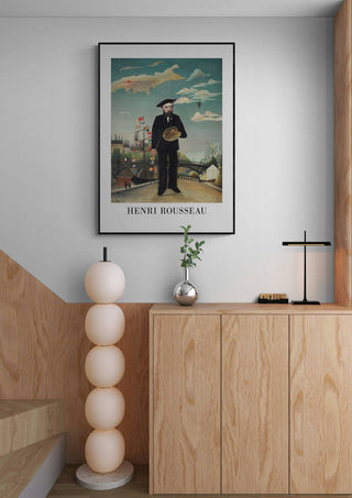 Framed "Self Portrait 1890 - Henri Rousseau" poster hanging above a modern wooden cabinet in a minimalist room.