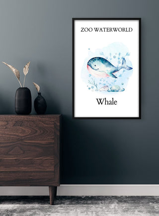 Framed Zoo Waterworld - Whale Plakat featuring a watercolor whale, displayed on a dark wall above a wooden dresser.