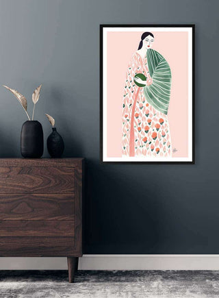 Framed "Pink Geisha" by Martina Karlsson displayed on a gray wall above a wooden dresser with vases.