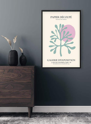 Framed Colorful Papier Decoupe Plakat featuring abstract botanical shapes, displayed above a dark wood dresser.