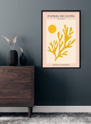 French art poster with yellow coral and circle, framed and hung above a wooden dresser in a modern room.