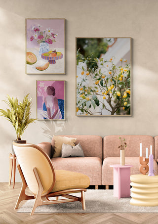 Modern living room with soft pink sofa, pastel decor, and Orange Capri artwork on the wall above the couch.