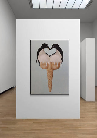 Art print of two penguins forming a heart shape over a double-scoop ice cream cone, displayed in a gallery.