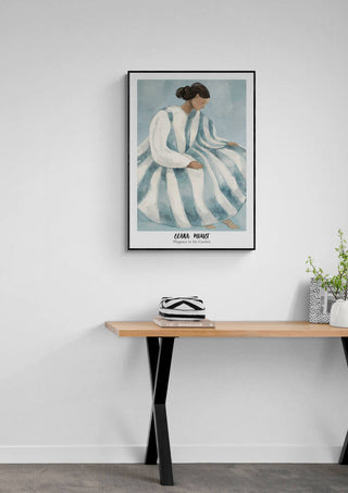 Framed "Elegance in the Garden - Elara Monet" art print hanging above a modern wooden desk with decor.