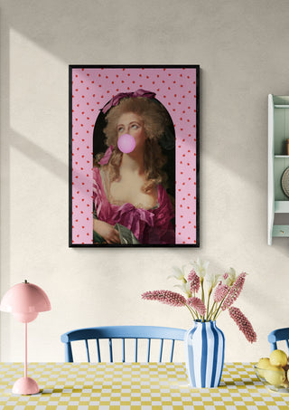 Framed "Lollipop Girl" art print featuring a classical woman blowing bubblegum, displayed in a colorful dining room.