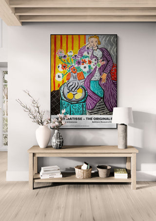 Framed "Purple Robe and Anemones" by Henri Matisse displayed above a modern console table in a bright room.