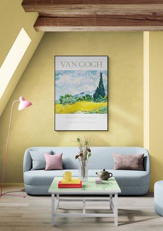 Framed "Wheat Field - Van Gogh" print displayed above a modern light blue sofa in a cozy living room.