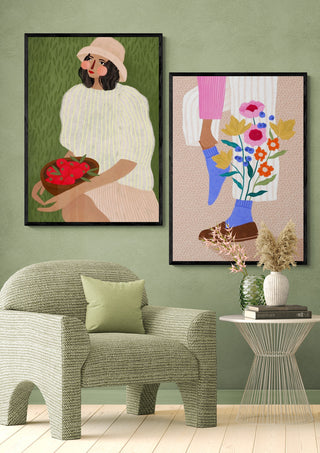 Art prints by Bea Muller featuring floral designs, displayed above a green patterned armchair and glass table.