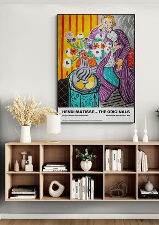 Framed "Purple Robe and Anemones" by Henri Matisse displayed above a modern wooden shelf with decor.