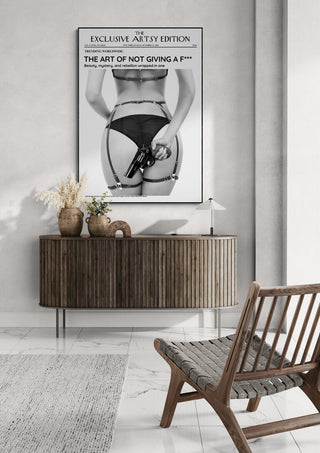 Modern living room with a poster for Not Giving a Fuck Hot Edition featuring bold black and white artwork above a sideboard.