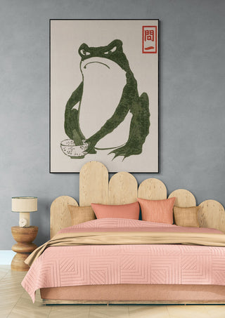 Grumpy Toad I - Matsumoto Hoji artwork displayed above a bed in a modern bedroom setting.