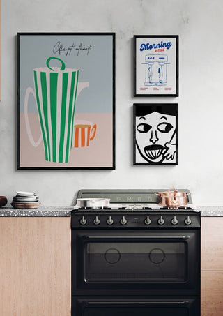 Kitchen with a stove and wall art, including a print featuring “Morning Cup” branding above the oven.