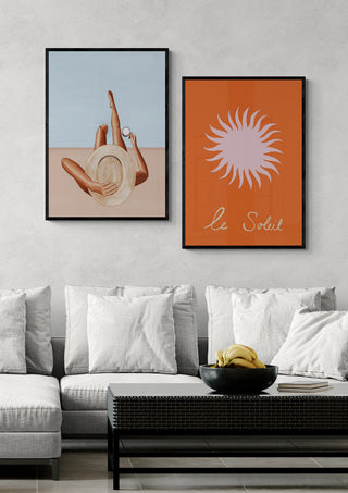 Framed Pink Soleil - Ivy Green artwork displayed above a modern sofa in a stylish living room.