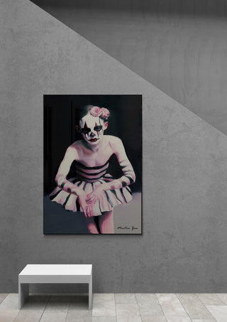 Art print of a ballerina with clown makeup and tutu, displayed on a gray wall above a white bench.