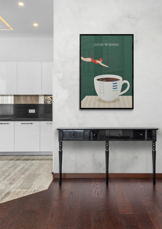Framed Good Morning Dive poster featuring a coffee cup, displayed above a black console table in a modern kitchen.