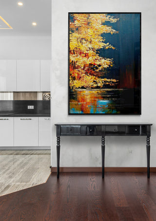 Golden River by Justyna Kopania framed on a modern wall above a black console table in a contemporary interior.